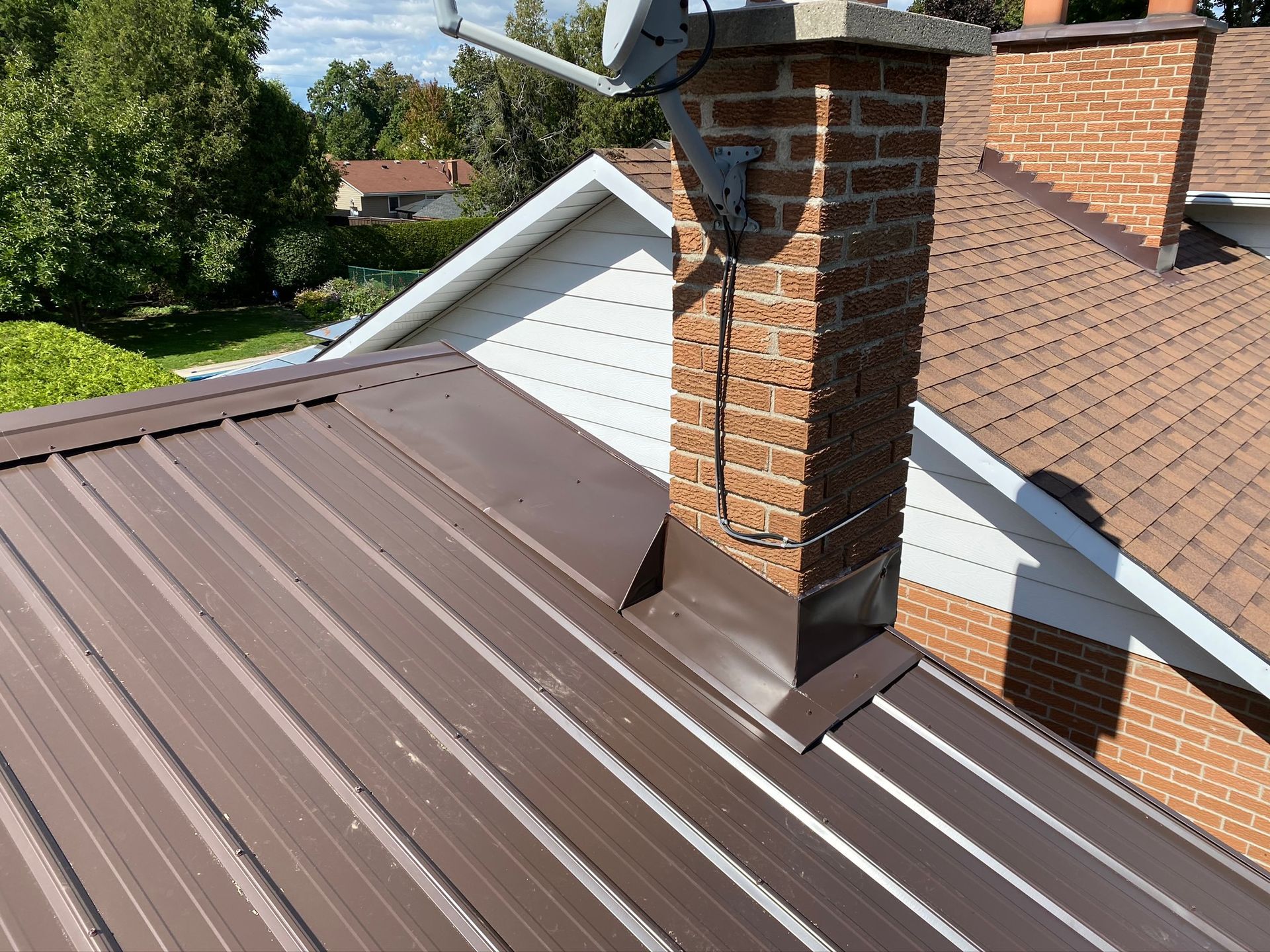 a brown metal roof with a chimney on top of it