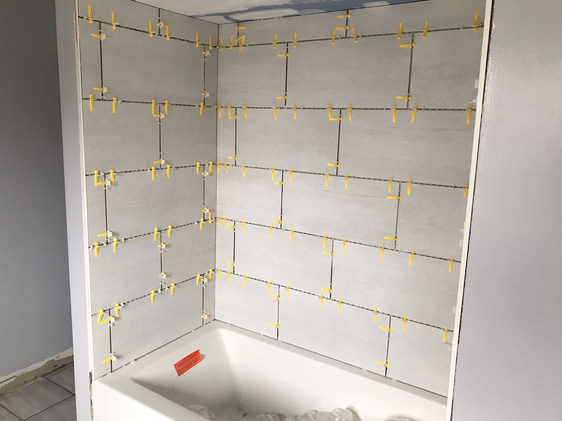 a bathtub is being tiled in a bathroom .