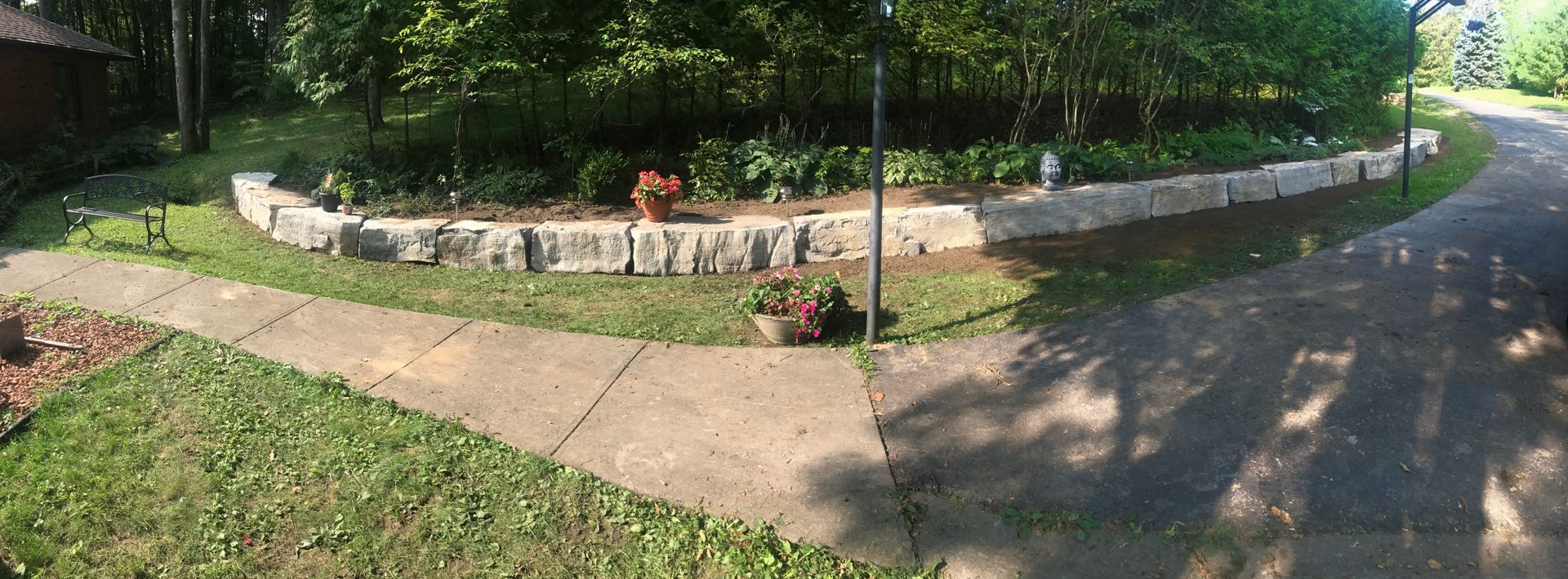 there is a stone wall in the middle of the yard .