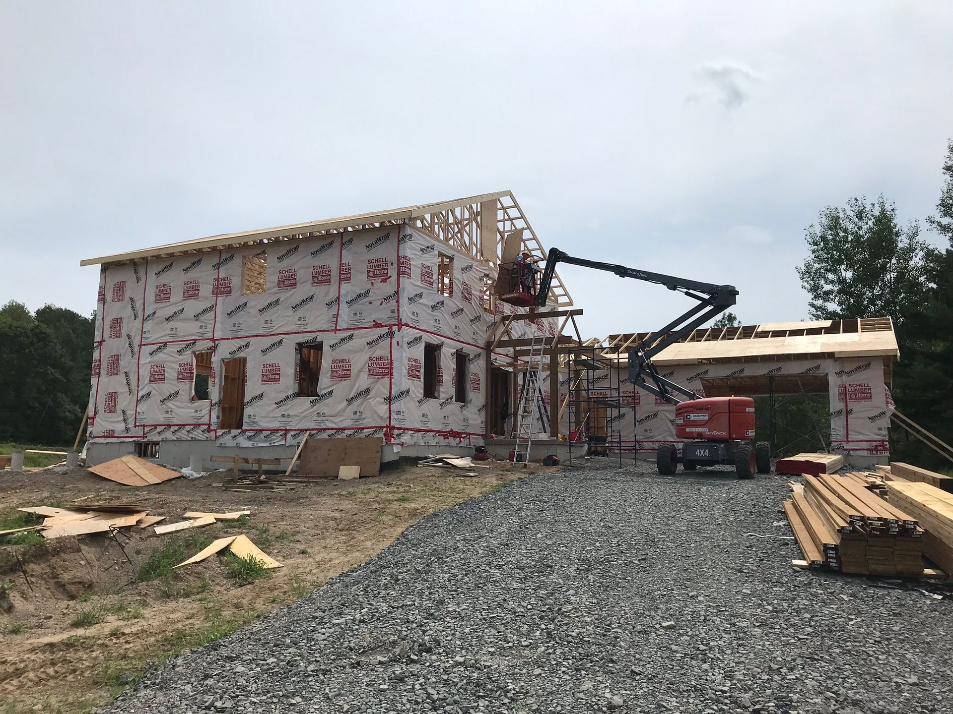 a large house is being built with a crane in front of it .