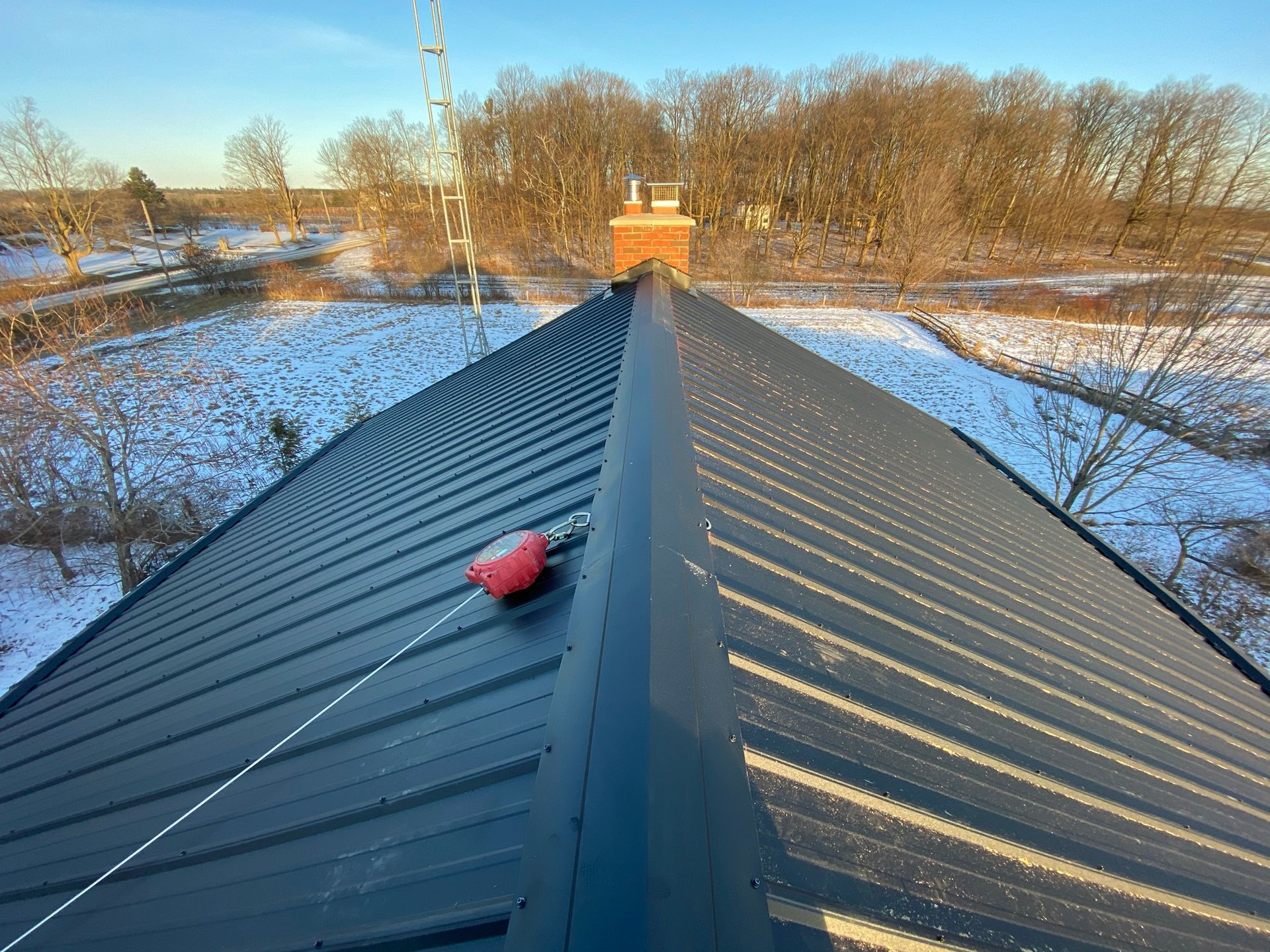 a black roof with a red tool on top of it .