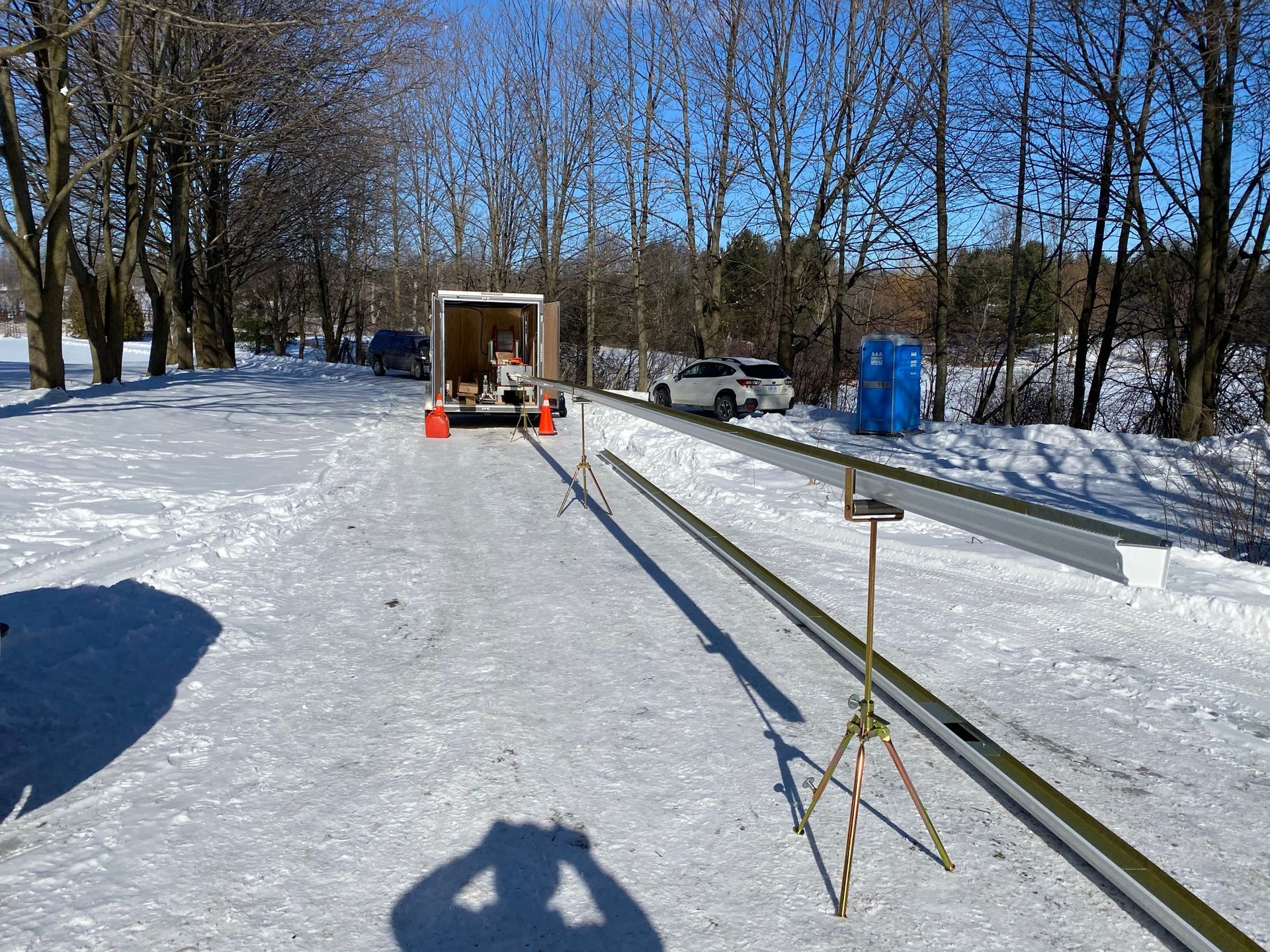 a truck is parked on the side of a snow covered road .