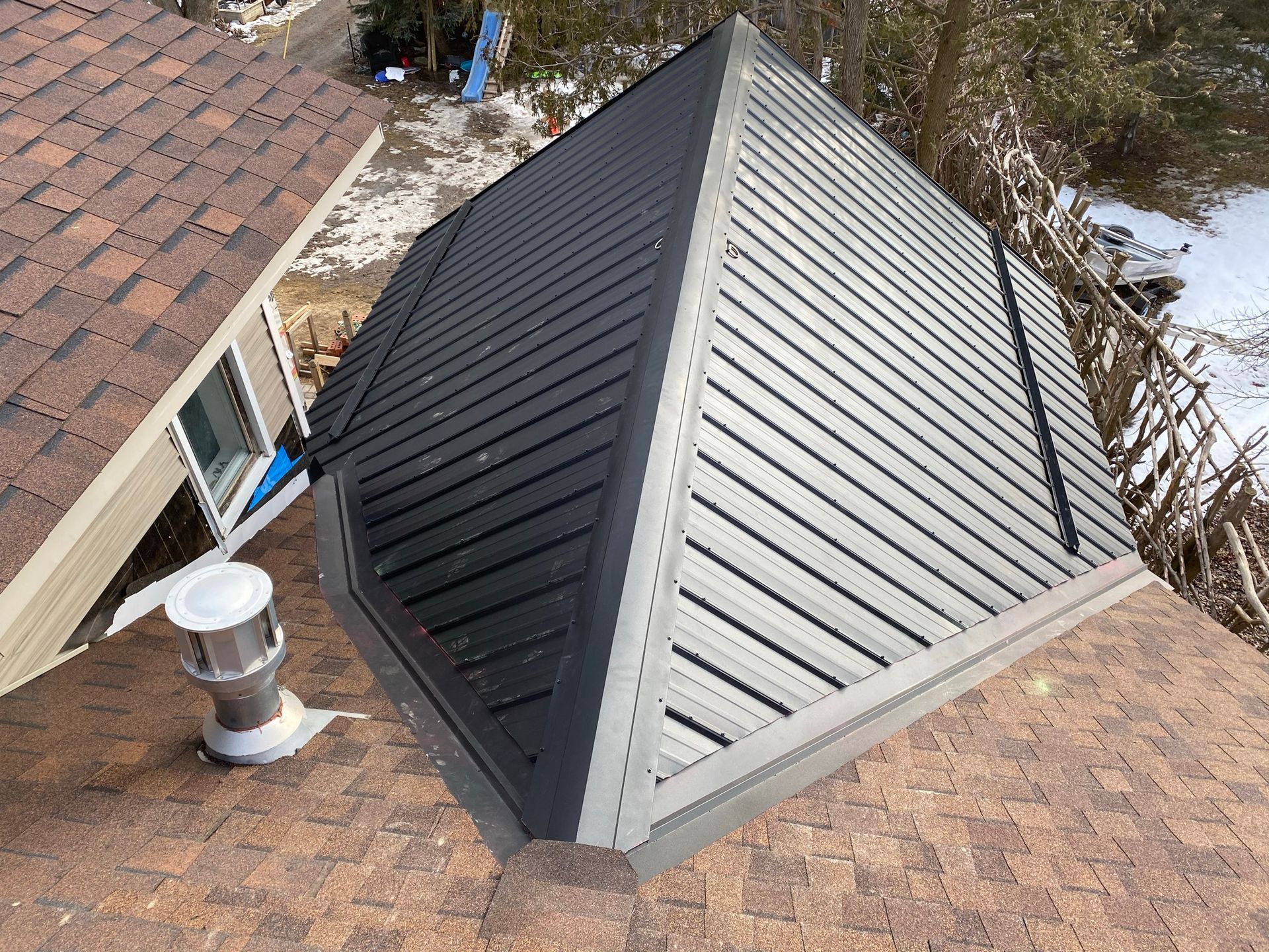 a pyramid shaped roof with a chimney on top of it .