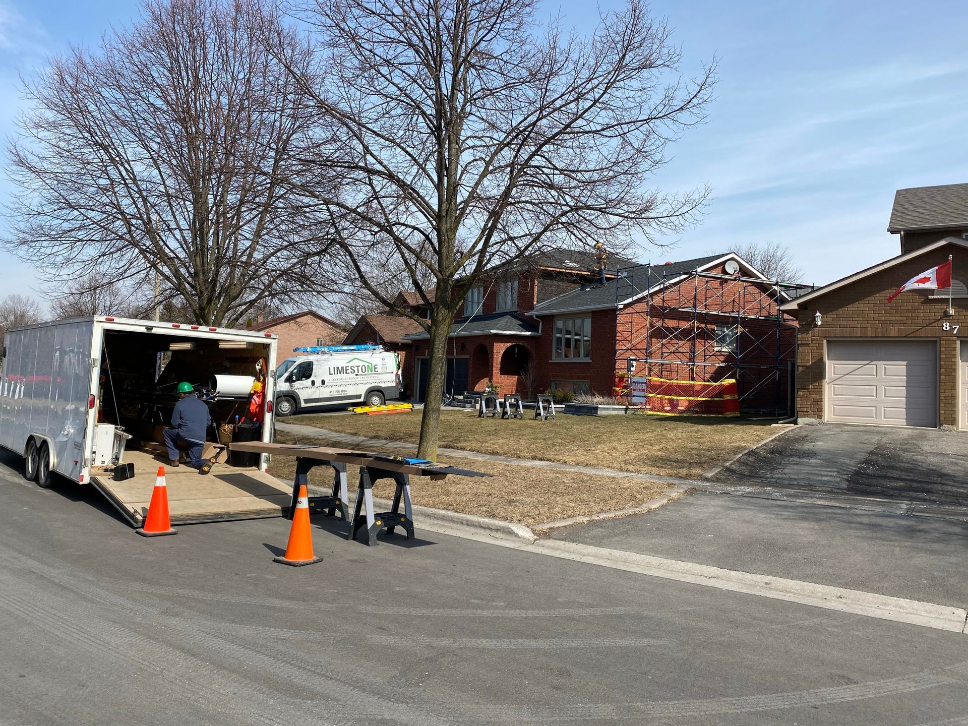 a truck is parked on the side of the road in front of a house .