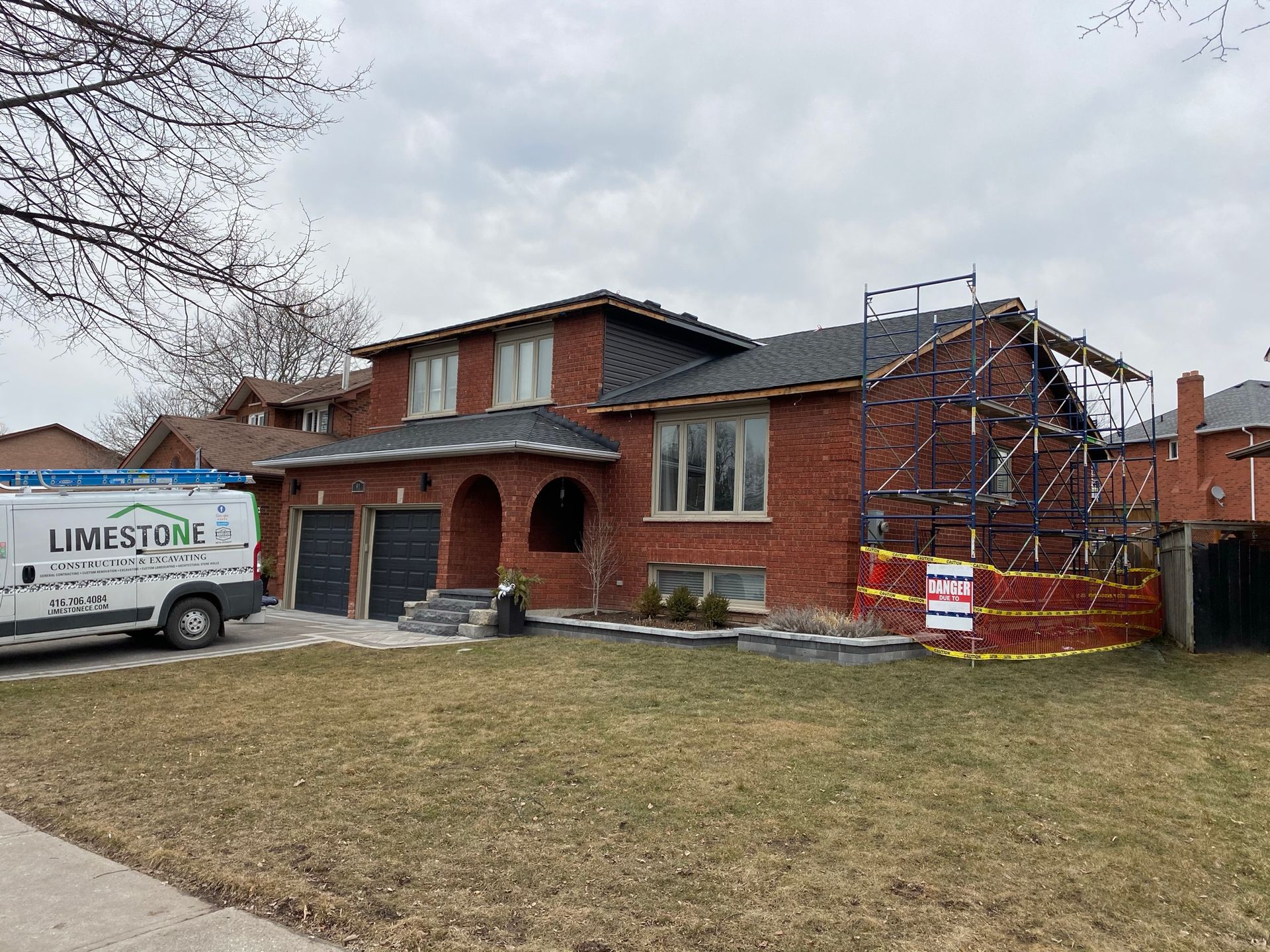 a white van is parked in front of a brick house .