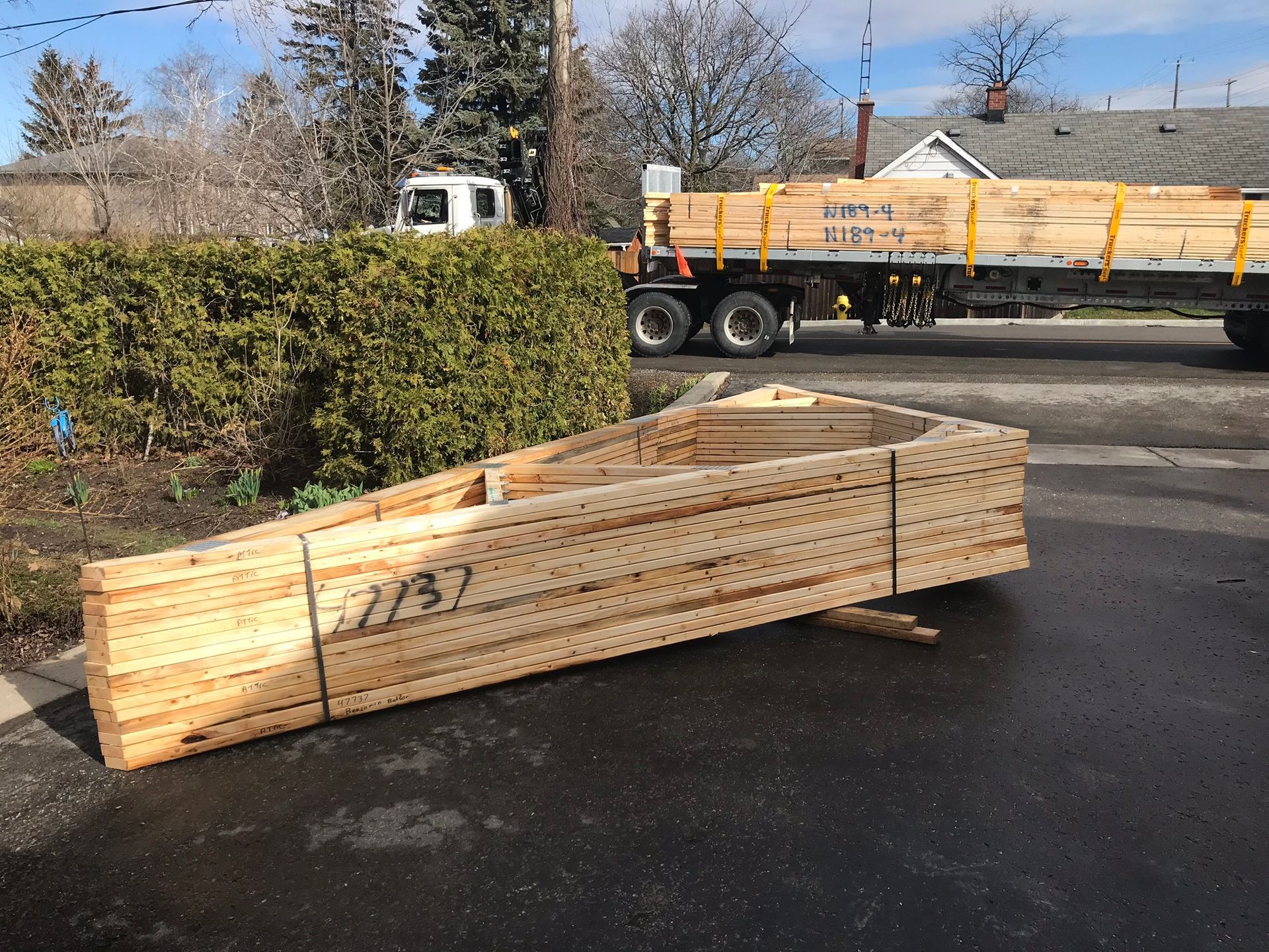 a truck is carrying a large stack of wood
