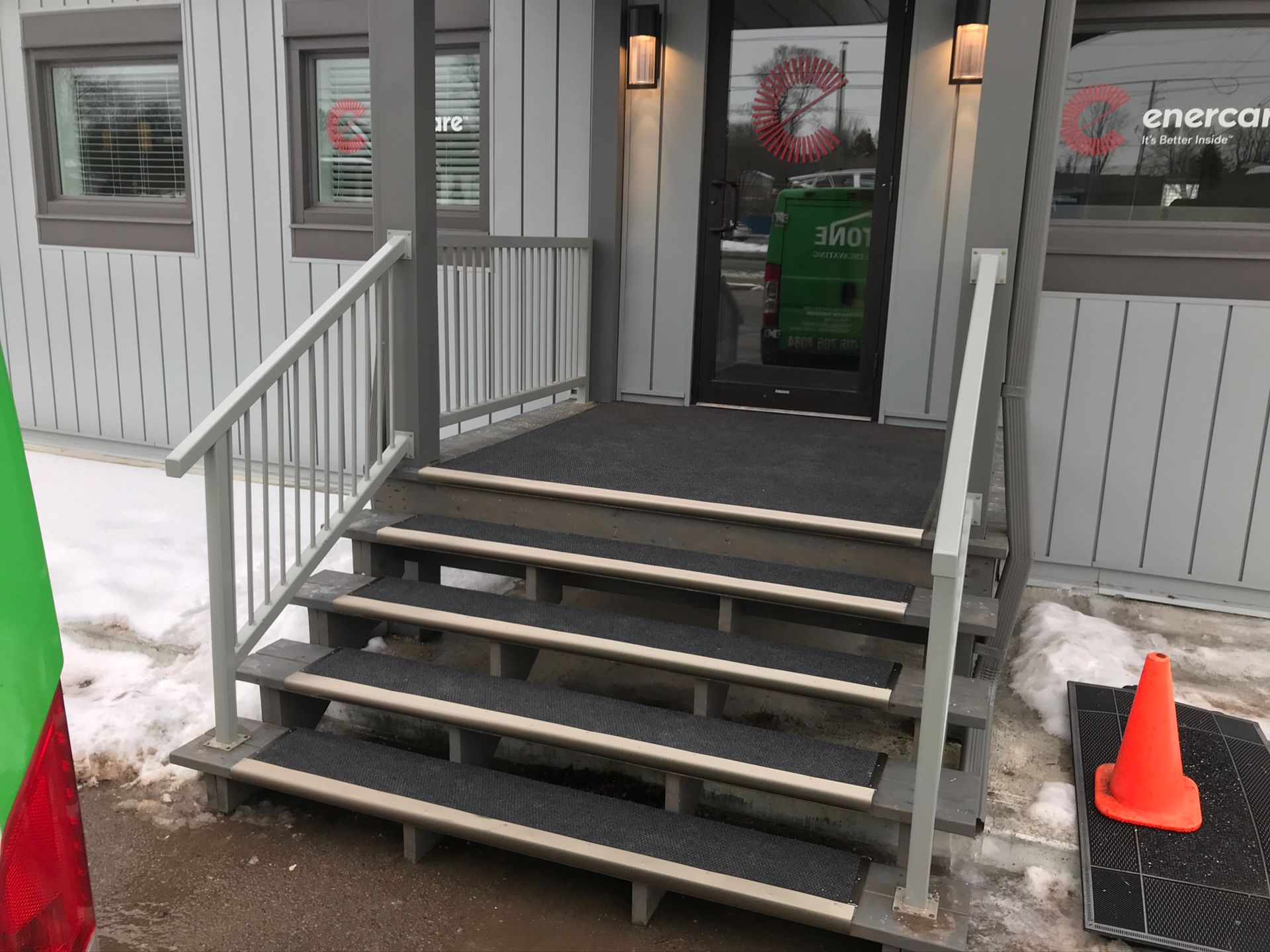 a set of stairs leading up to the front door of a building .