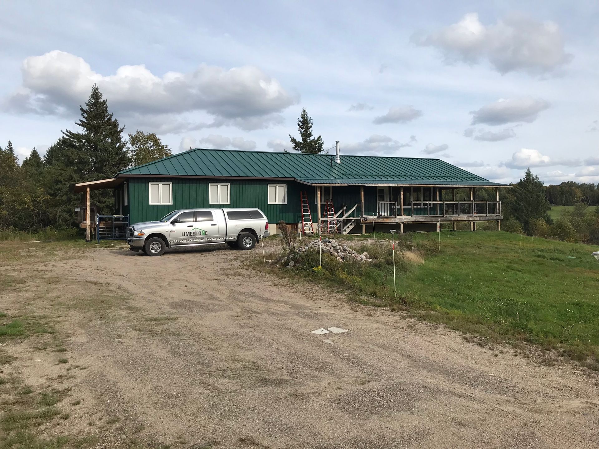 a truck is parked in front of a house with a green roof .