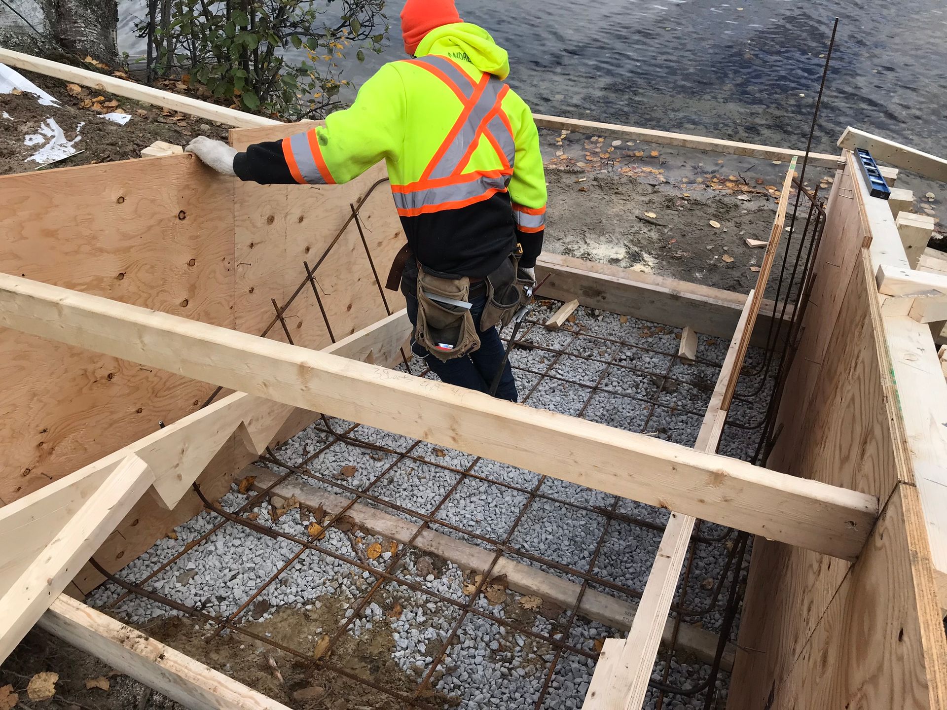 a construction worker is working on a wooden structure .