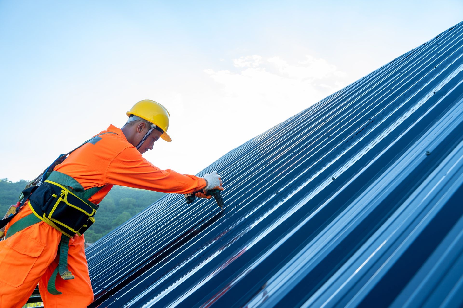 A man is working on a roof with a hammer.