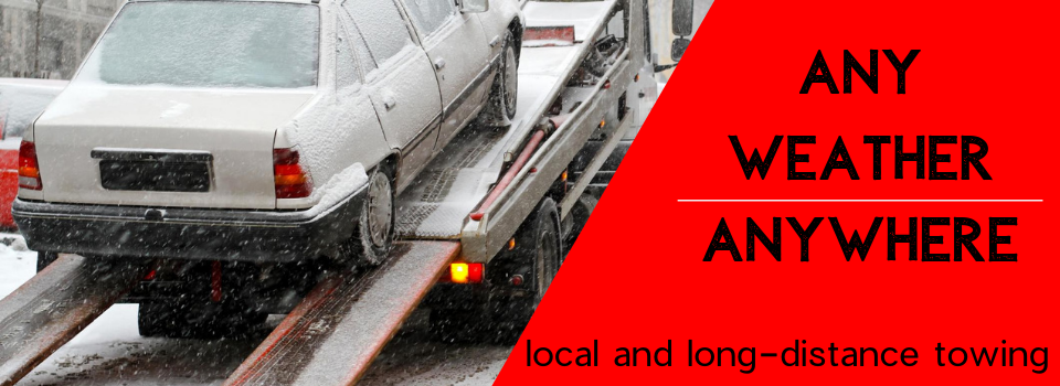 White car being towed on a flatbed tow truck in a snowy environment with the text