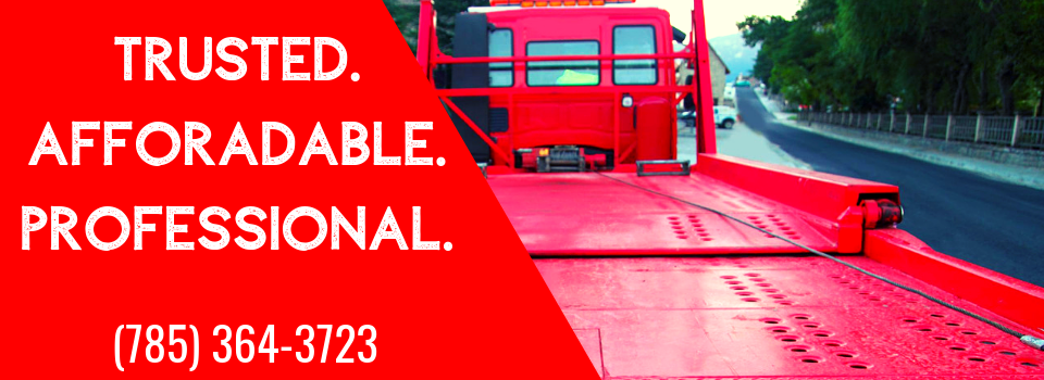 Red tow truck on the road with text: