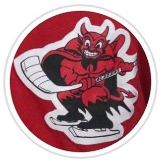 Red devil mascot skating on ice, holding a hockey stick on a red circular logo