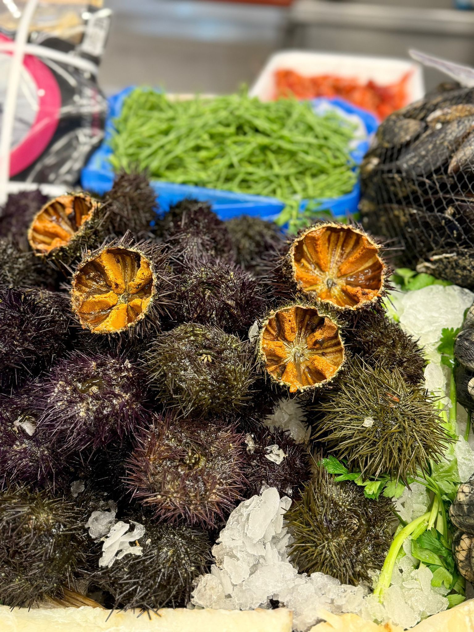 Piatto di cibo su un tavolo apparecchiato per cenare, contro una parete decorata con motivi floreali blu e oro.