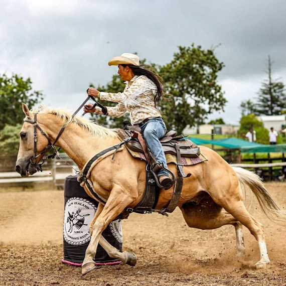 Three people smiling at a food truck: One makes a peace sign, one a victory sign, and all wear black shirts.