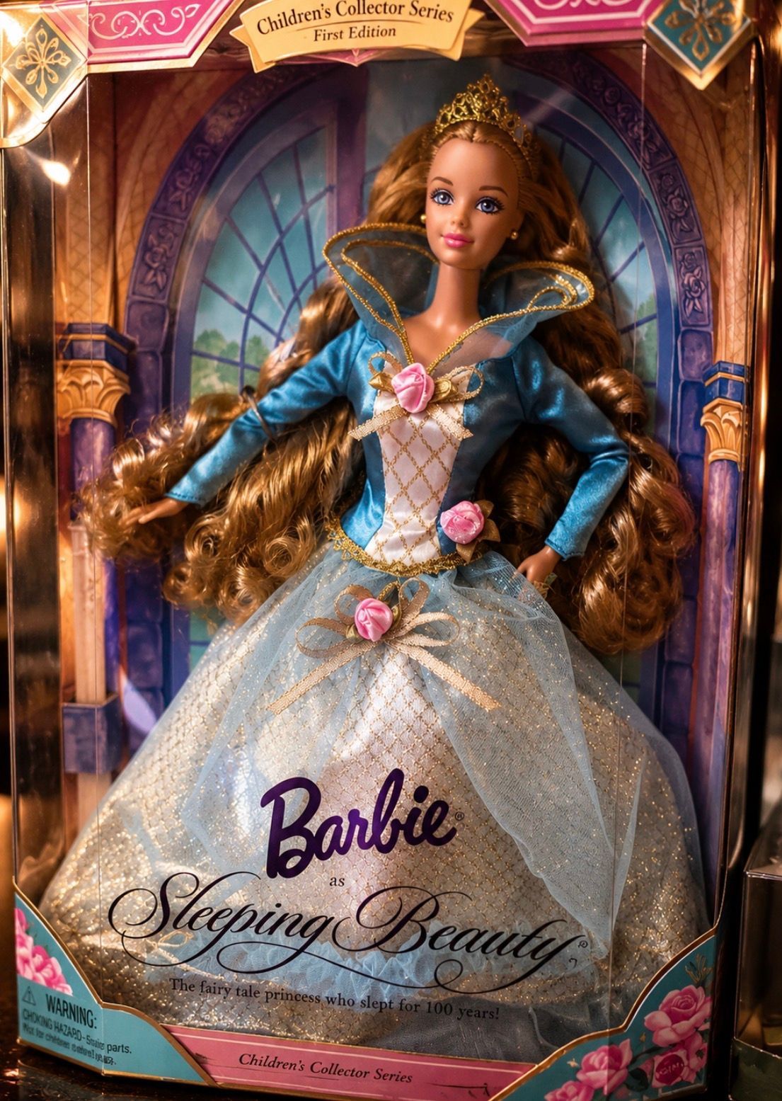 Barbie Sleeping Beauty doll in a blue gown inside decorative pink and gold packaging
