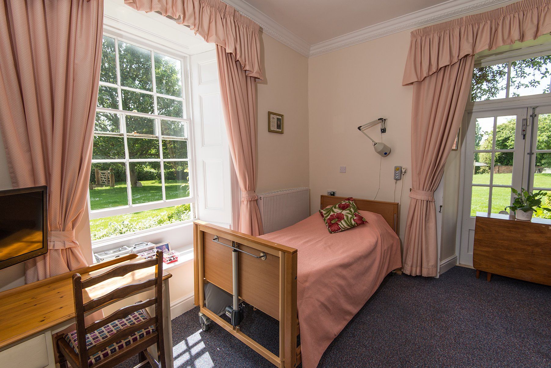 wooden bed with beautiful curtains fitted