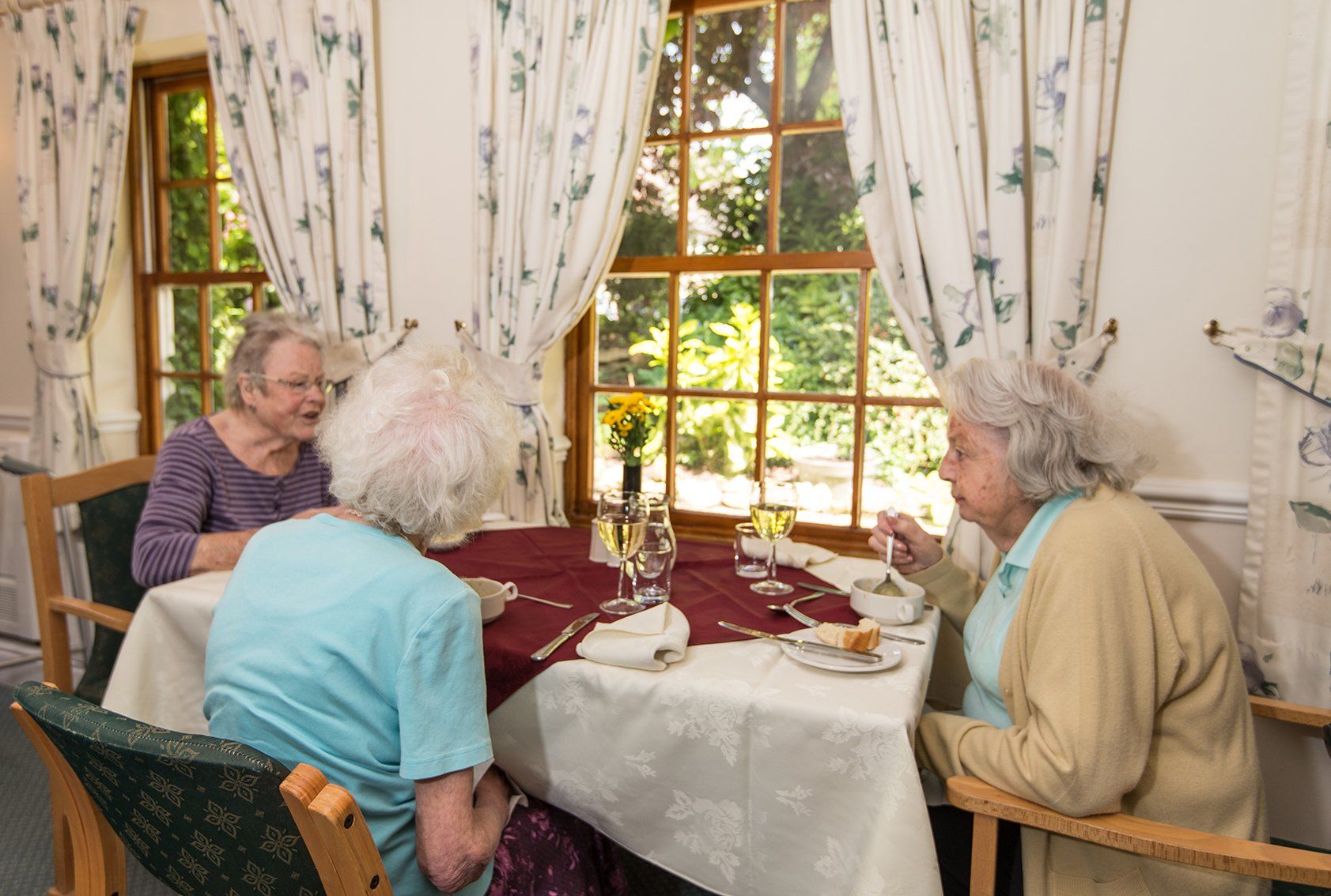 elderly people having their food at the dining area