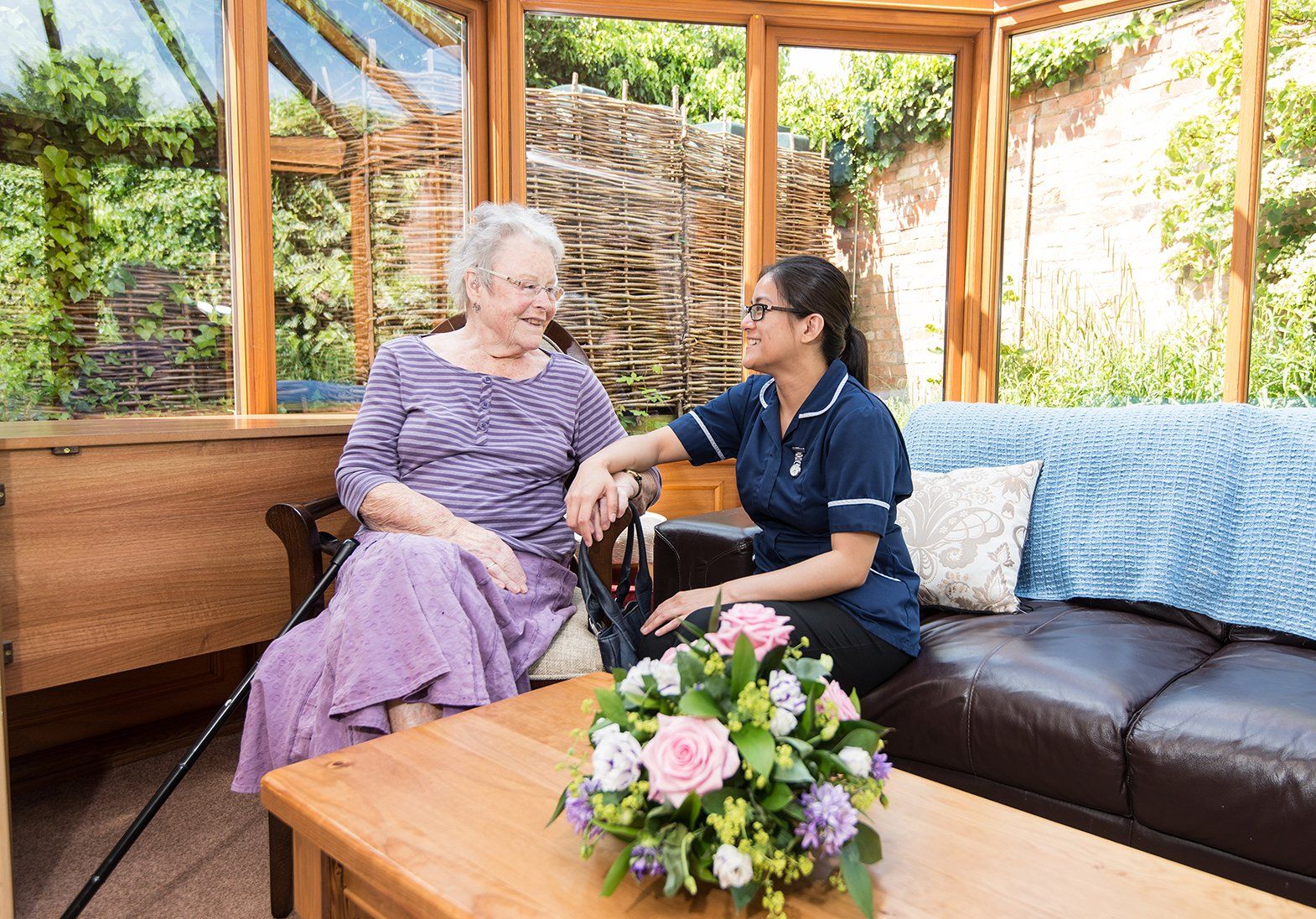a carer talking with an elderly woman