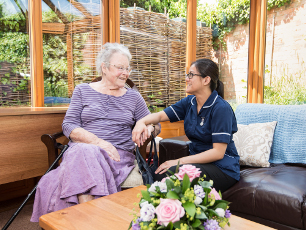 a carer assisting an elderly women