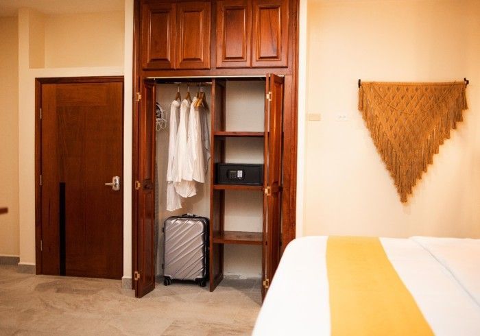 There is a suitcase in the closet in the bedroom.