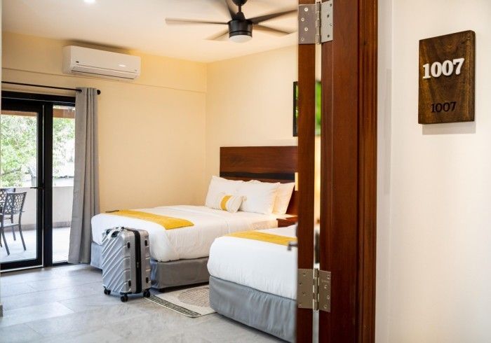 A hotel room with two beds and a sign that says 1007.