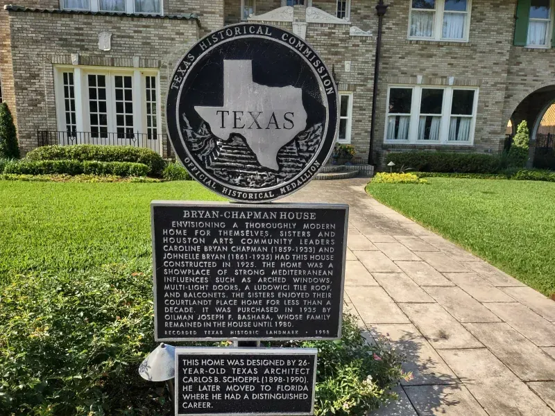Bryan-Chapman House with historical marker in front of a stone building with green lawn.