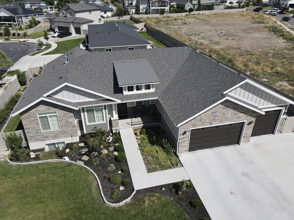 An aerial view of a large house with a gray roof.