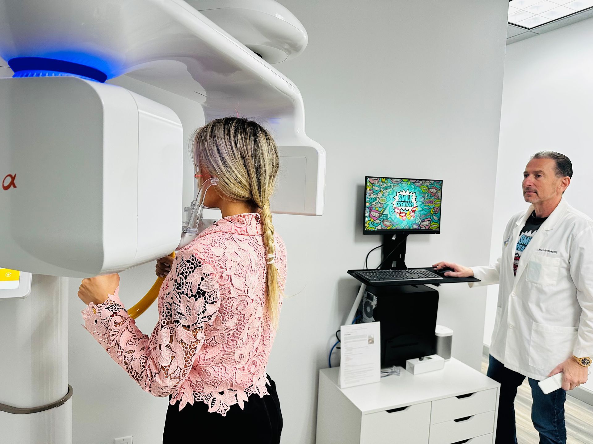 A woman is getting an x-ray of her teeth in a dental office.
