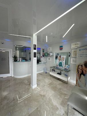 A dental office with a white ceiling and a marble floor.