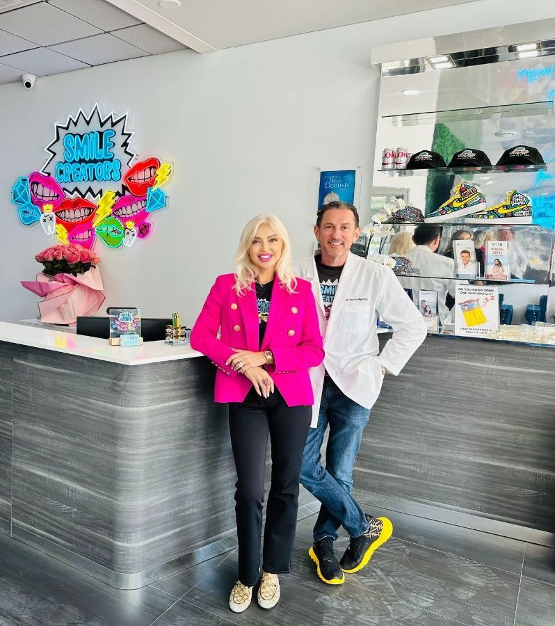 A man and a woman are standing in front of a counter in a dental office.