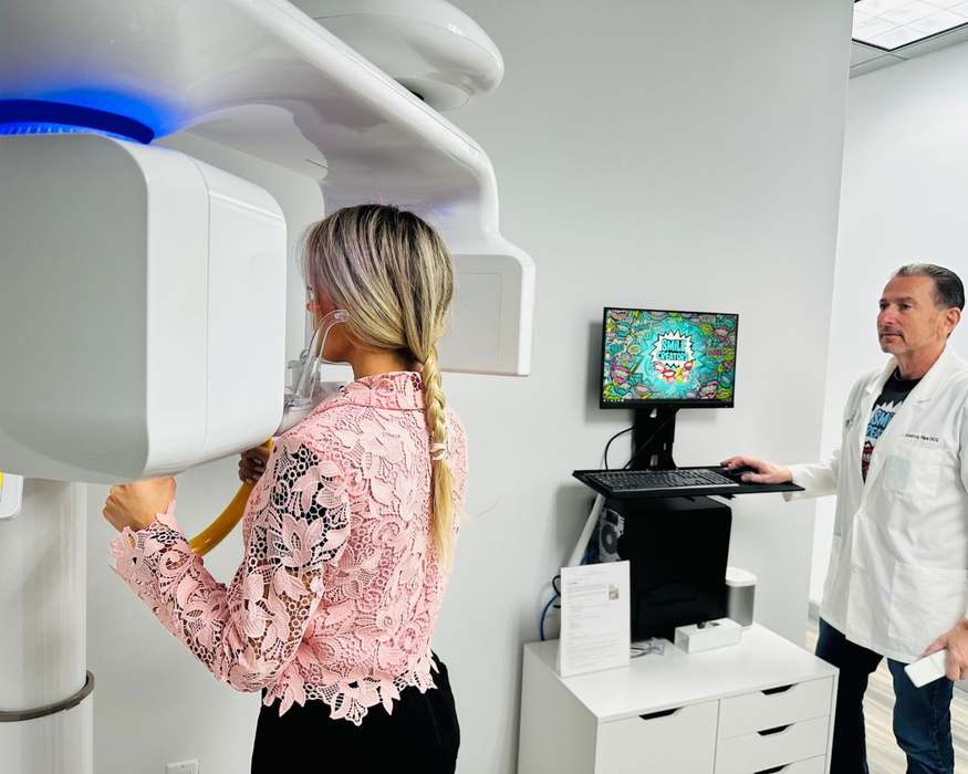 A man and a woman are standing next to each other wearing shirts that say `` your smile creator ''.