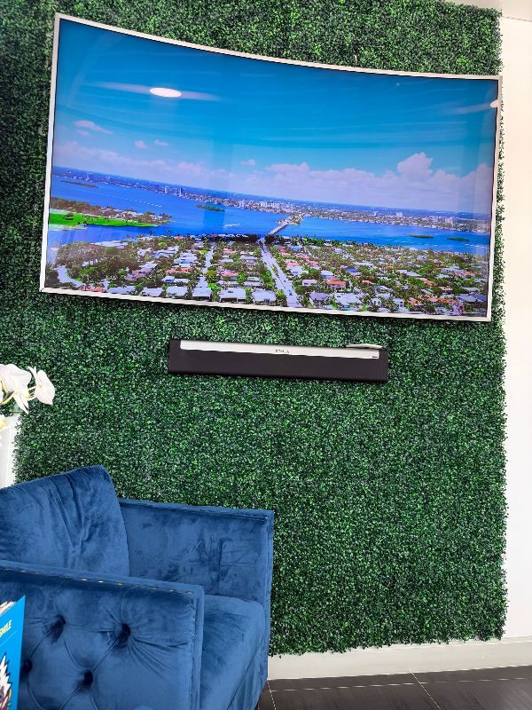 There is a large picture on the wall above the chairs.