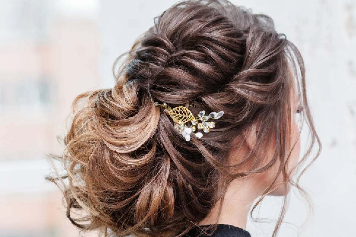 A woman with an elegant hairstyle and floral hair accessory at Lux Hair Bar near Lexington, Kentucky (KY)