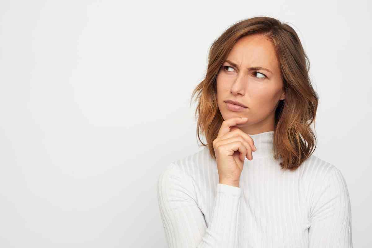 Someone thinking about something with their hand on their chin at Lux Hair Bar near Lexington, Kentucky (KY)