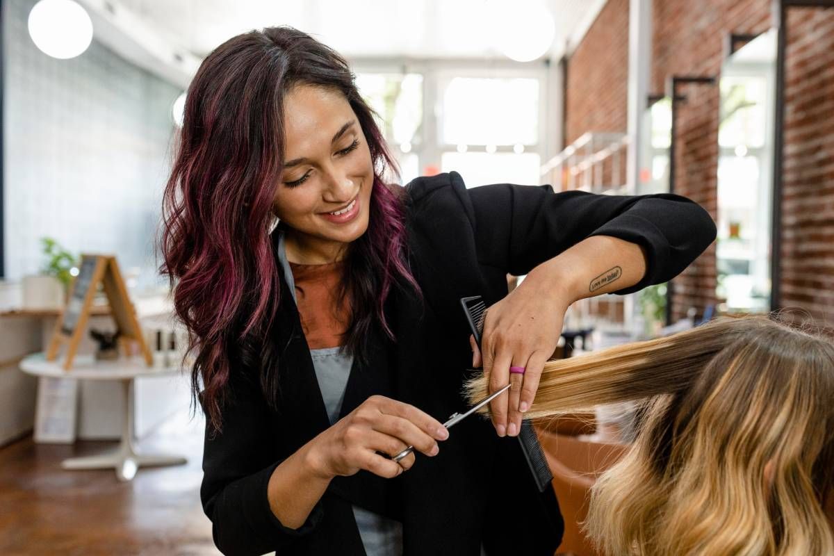 Someone getting her hair cut by a professional at Lux Hair Bar near Lexington, Kentucky (KY)