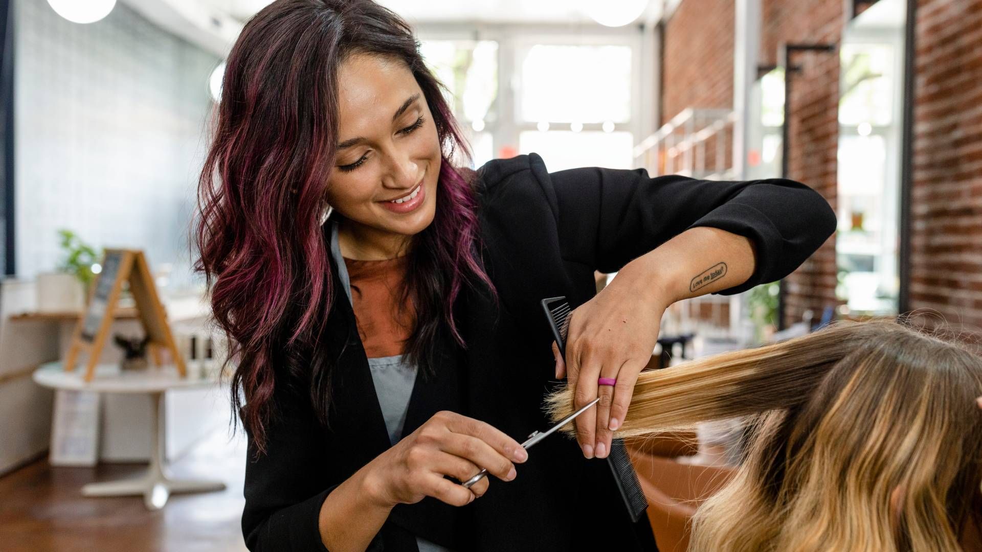 Someone getting her hair cut by a professional at Lux Hair Bar near Lexington, Kentucky (KY)