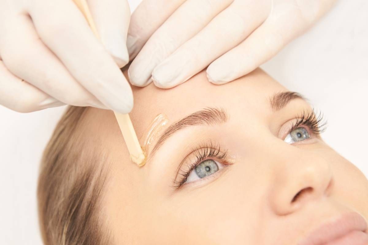 Someone getting their eyebrows waxed by a professional near Lexington, Kentucky (KY)