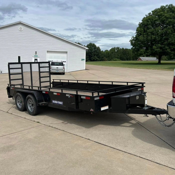 A trailer is being towed by a truck in a parking lot