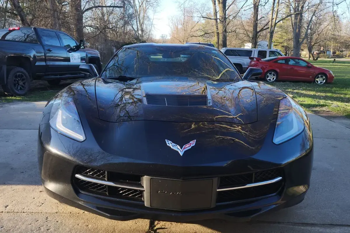 Black Chevrolet Corvette parked outside.