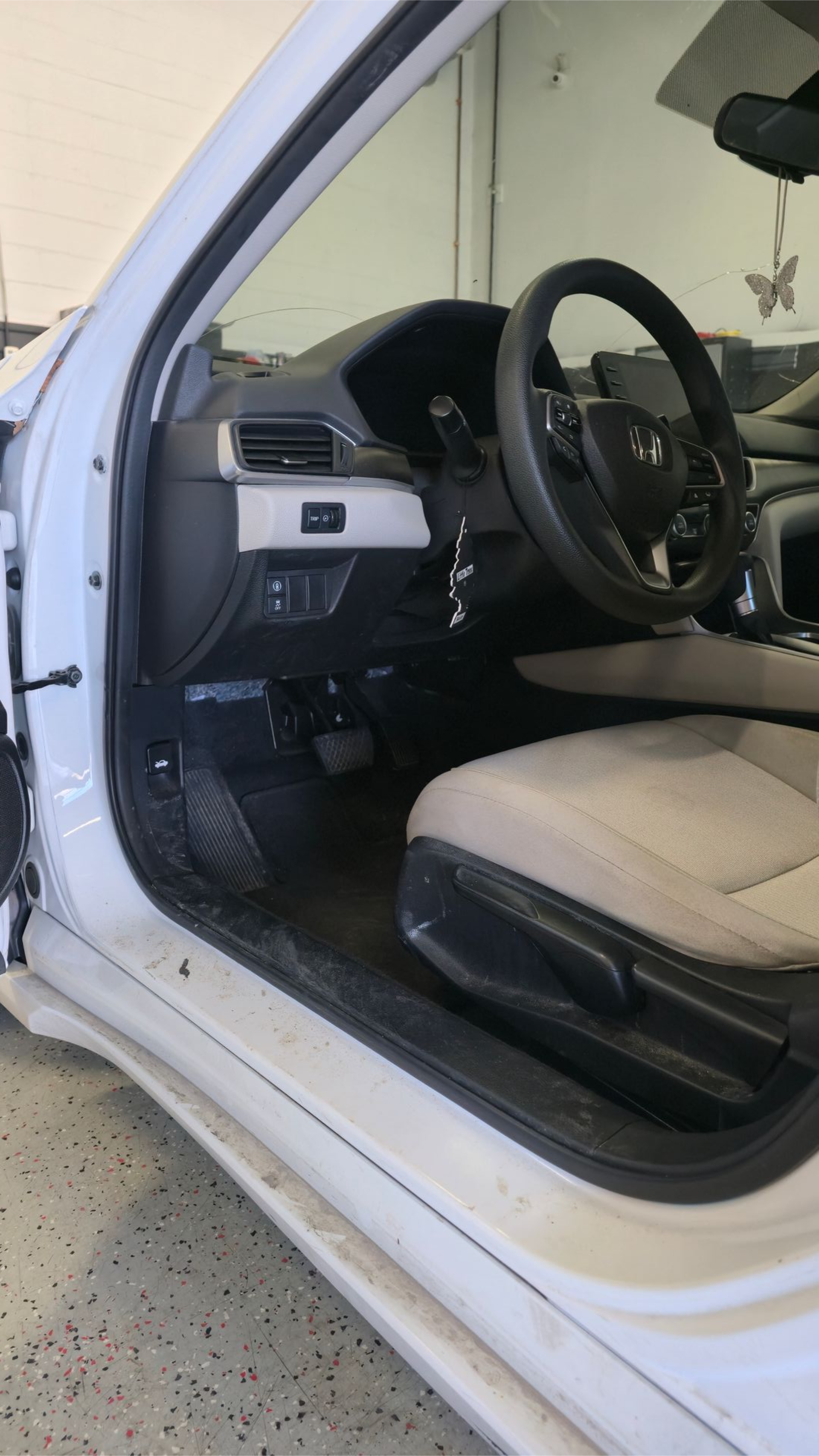 Open rear of silver SUV with seats folded down, revealing spare tire and cargo area.