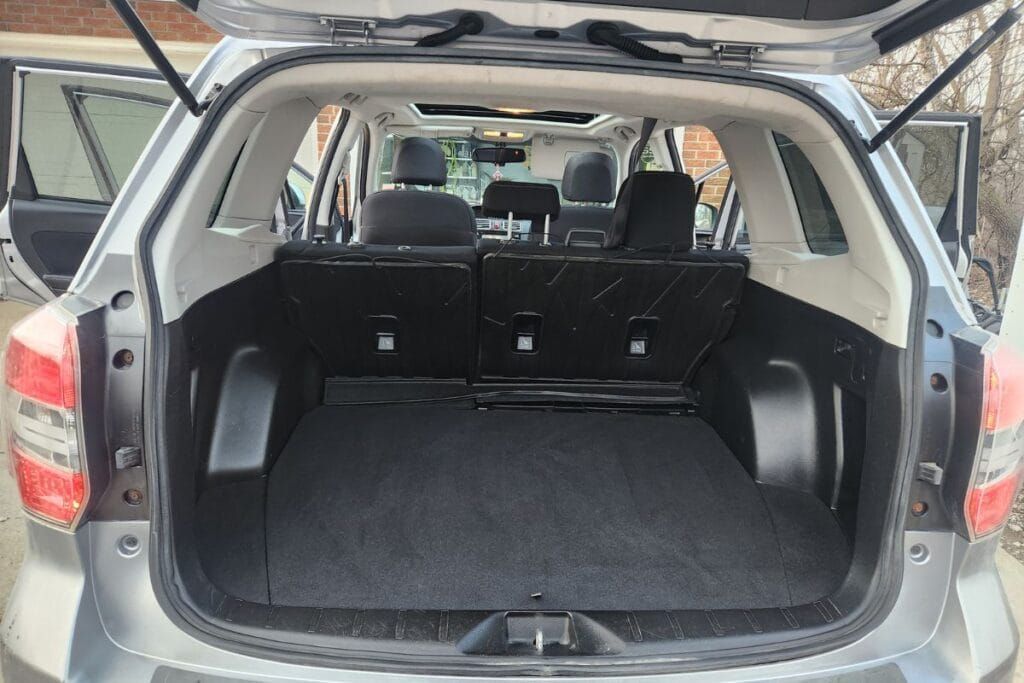 Open trunk of a gray Subaru SUV, revealing the cargo area.