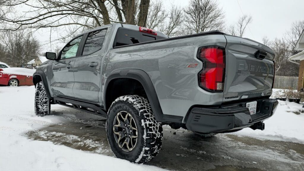 Gray Chevy pickup truck in snowy driveway.