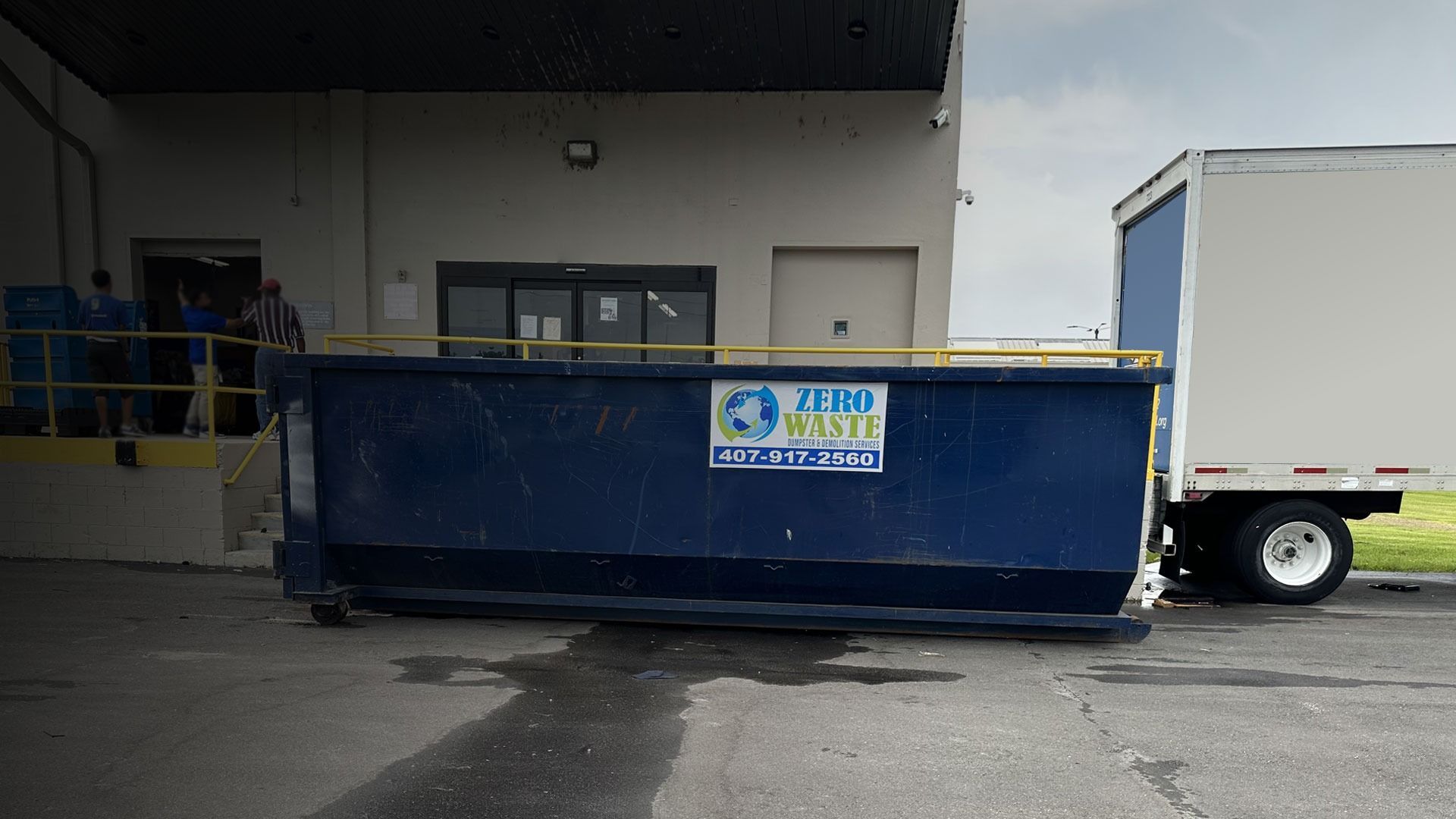 Blue dumpster labeled 