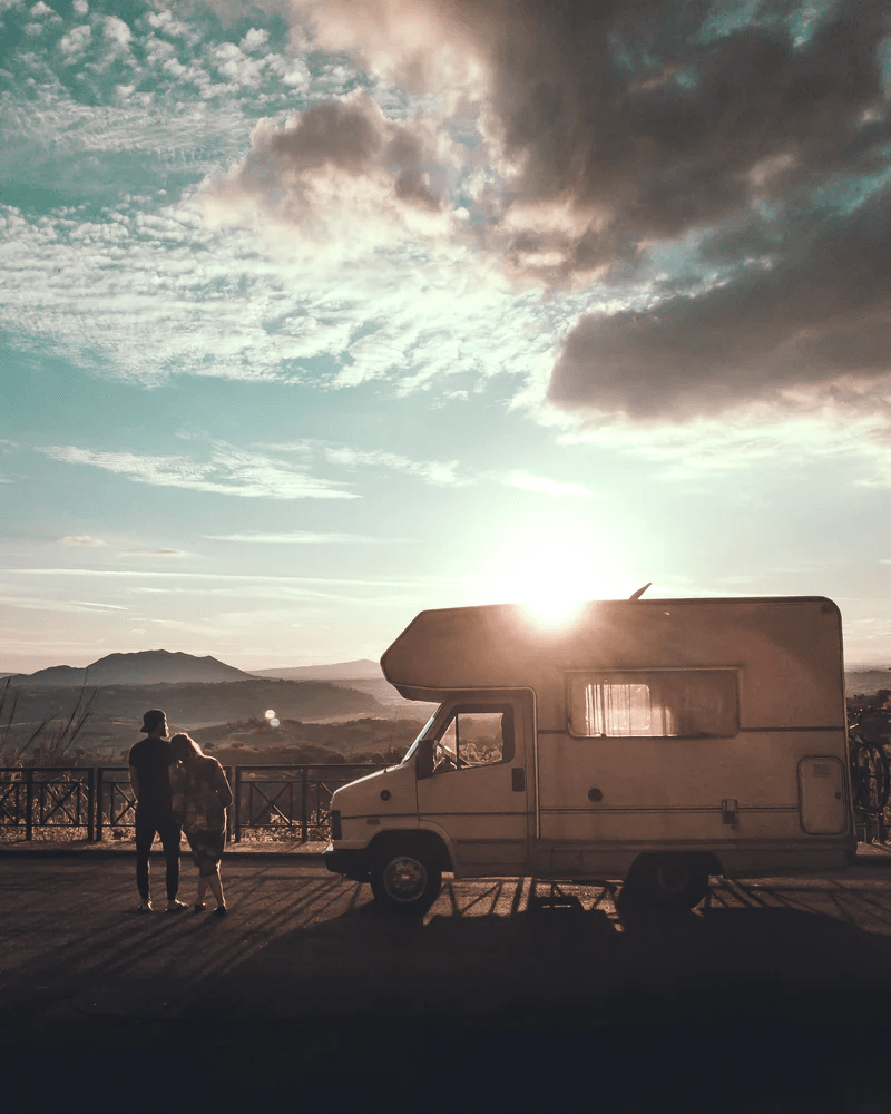 Couple watching sunset next to their motorhome