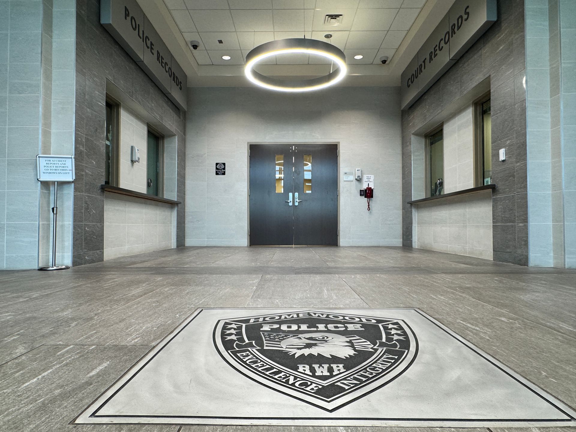 A police logo is on the floor of a building