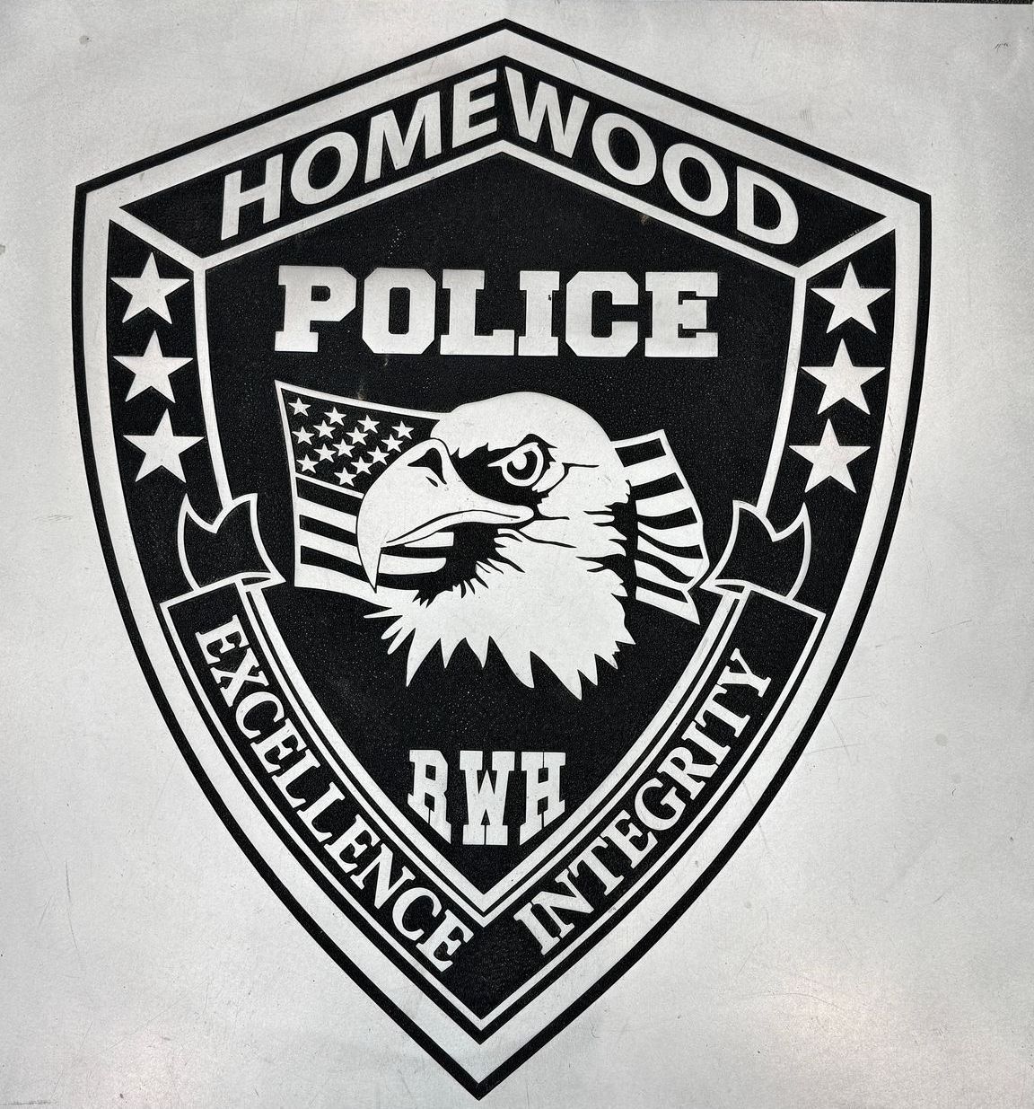 A black and white emblem for the homewood police