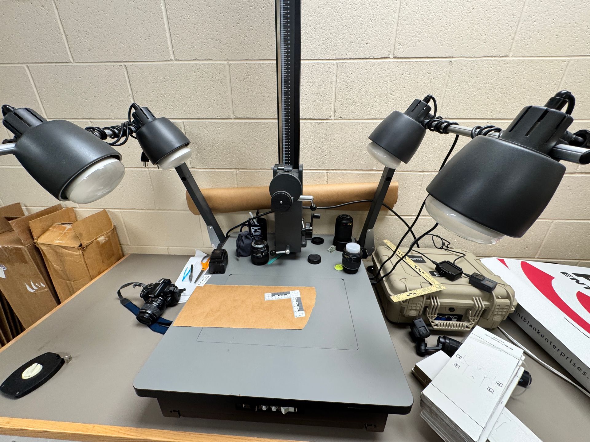 A table with a scanner and lamps on it