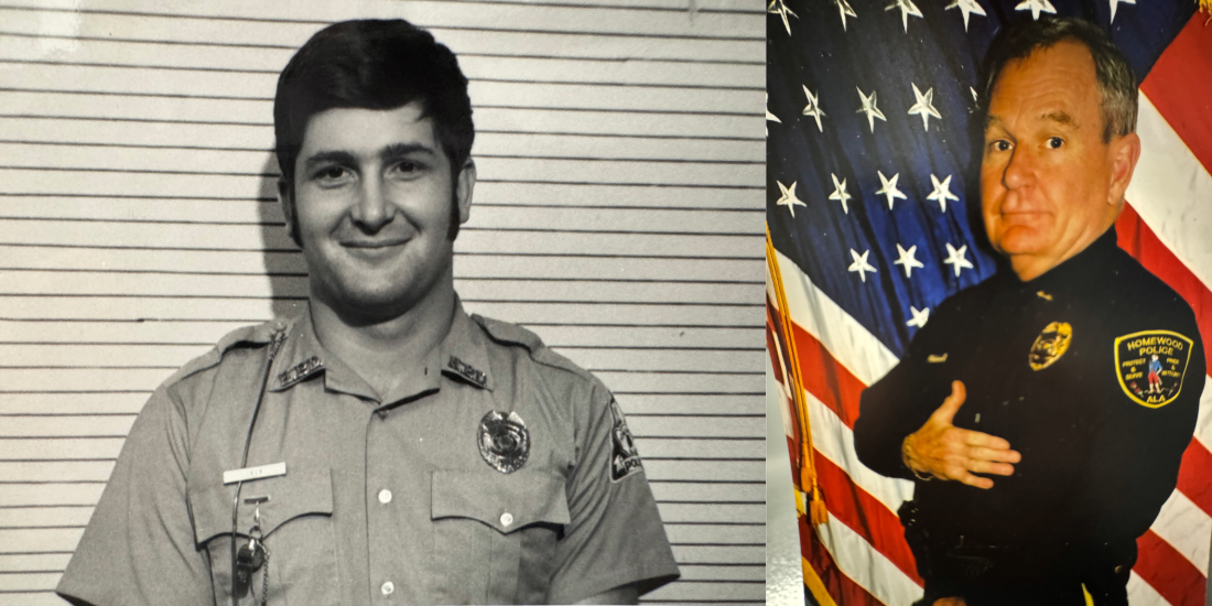 Two police officers are posing for a picture in front of an american flag.