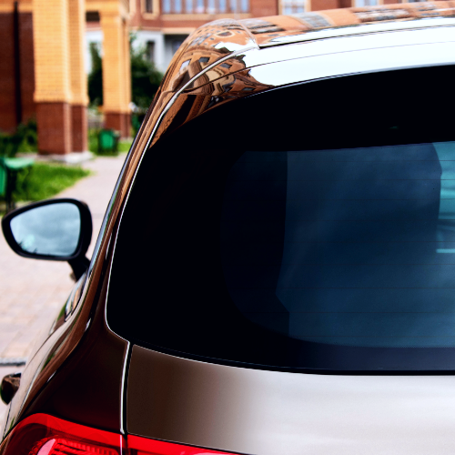 A car is parked in front of a brick building